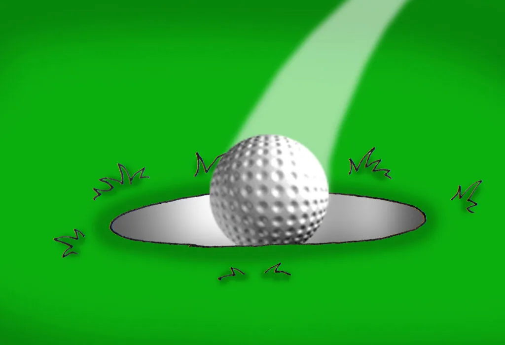 Golf ball resting in circular hole on green surface with impact lines and overhead lighting